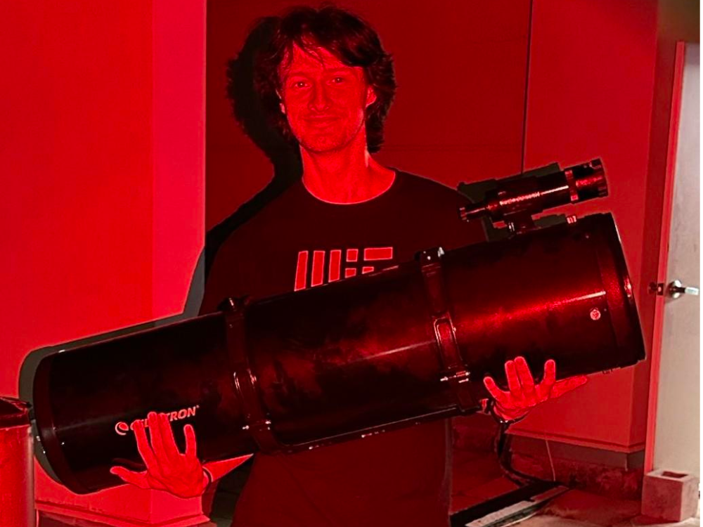 Holding an 8-inch Newtonian telescope at the Ortega Observatory